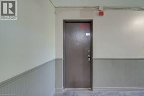 Waterloo apartment for rent - A grey door in a room with a grey tile wall.
