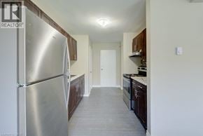Waterloo apartment for rent - A kitchen with a refrigerator on the left and a counter on the right.