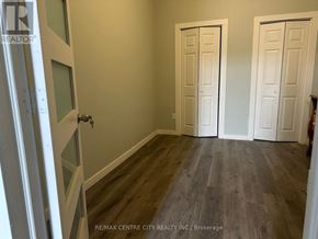 London East (East K) multi-family for rent - A room with a wooden floor and white doors.