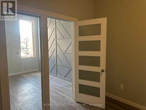 London East (East K) multi-family for rent - A glass door with a geometric pattern on the other side is open.
