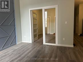 London East (East K) multi-family for rent - A room with a wooden floor and a white door with a glass window.