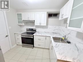 Oshawa (Kedron) apartment for rent - A white bathroom with a sink, mirror, and shower.