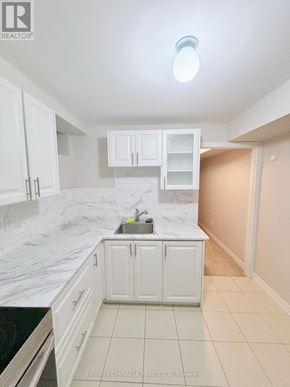 Oshawa (Kedron) apartment for rent - A spacious room with white walls and a carpeted floor.