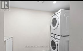 Oshawa (Kedron) apartment for rent - A stack of white washing machines in a laundry room.