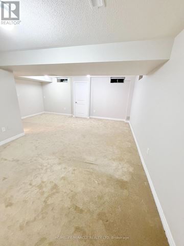Oshawa (Kedron) apartment for rent - A stainless steel refrigerator in a kitchen with white tiles.