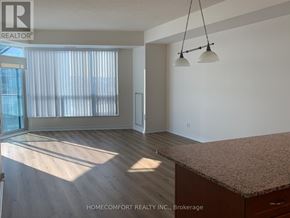 Barrie (City Centre) condo for rent - A room with a large window and a wooden floor.