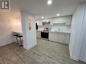 Mississauga (Churchill Meadows) apartment for rent - A white kitchen with a black stove top oven.