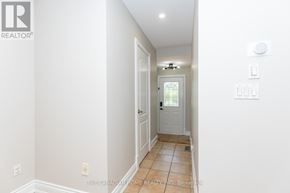 Mississauga (Meadowvale Village) apartment for rent - A hallway with a white door and tiled floor.
