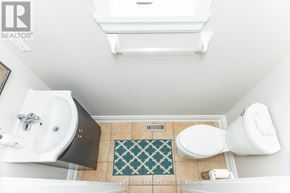 Mississauga (Meadowvale Village) apartment for rent - A bathroom with a toilet, sink, and a rug.