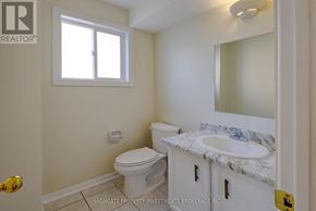 Mississauga (Creditview) apartment for rent - A white toilet sits in a bathroom with a marble counter top.