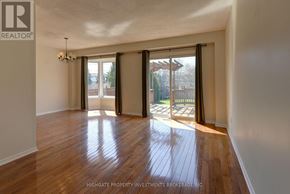 Mississauga (Creditview) apartment for rent - A room with wooden flooring and sliding glass doors leading to a backyard.