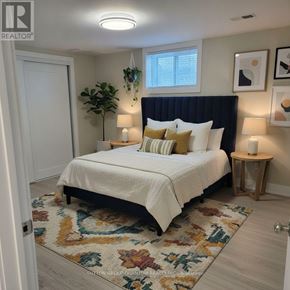 Burlington (Appleby) apartment for rent - A bedroom with a white bed and a black headboard.