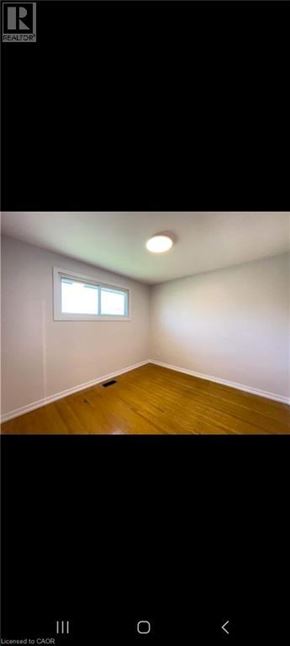 Hamilton apartment for rent - A room with a window and wooden floor.