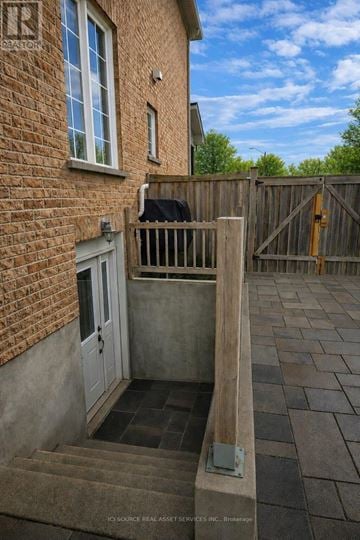 Richmond Hill (Rouge Woods) apartment for rent - A small patio with a white door and a brick wall.