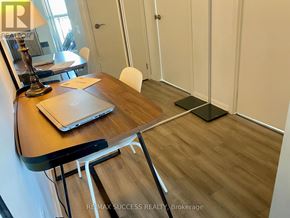 Toronto (Yorkdale-Glen Park) condo for rent - A room with a desk, laptop, chair, and a lamp.