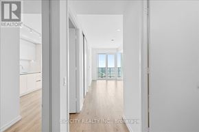 Vaughan (Vaughan Corporate Centre) condo for rent - A long hallway with white walls and wood floors.