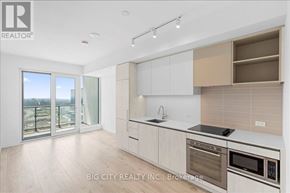 Vaughan (Vaughan Corporate Centre) condo for rent - A modern kitchen with white cabinets and stainless steel appliances.