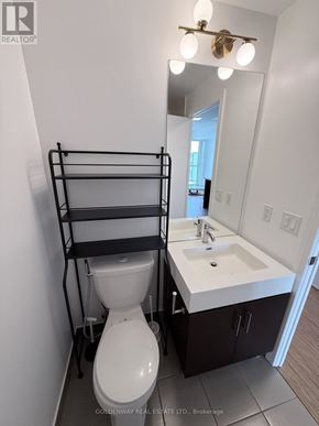 Toronto (Thorncliffe Park) condo for rent - A bathroom with a toilet, sink, and mirror.