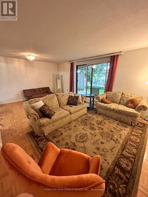 Toronto (Hillcrest Village) townhouse for rent - A room with wooden flooring and a window.