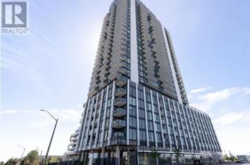 Vaughan (Vellore Village) condo for rent - A tall building with many windows and balconies is under construction.