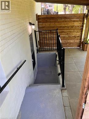 Kitchener apartment for rent - A stairway with a black railing and a white wall.