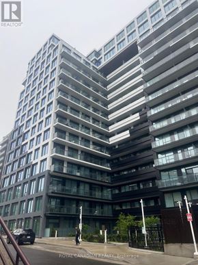 Toronto (York University Heights) condo for rent - A tall building with many windows is the focus of this image.