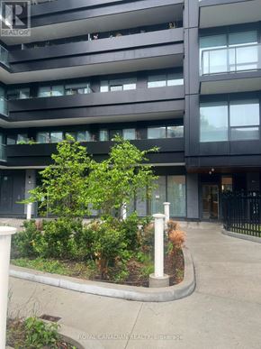 Toronto (York University Heights) condo for rent - A building with a balcony and a tree in front of it.