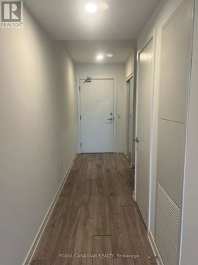 Toronto (York University Heights) condo for rent - A long hallway with wood floors and white walls.