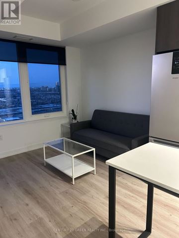 Mississauga (City Centre) condo for rent - A modern living room with a grey sofa and a coffee table.