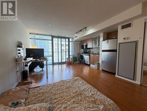 Toronto (Bay Street Corridor) condo for rent - A living room with a television, a couch, and a dining table.