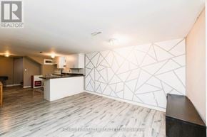 Toronto (Wexford-Maryvale) apartment for rent - A realtor office with a white reception desk and a white wall with a geometric pattern.