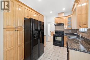 Vancouver apartment for rent - A kitchen with wooden cabinets and black appliances.