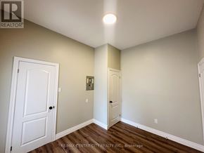 St. Thomas fourplex for rent - A room with a white door and a white wall with a light switch.