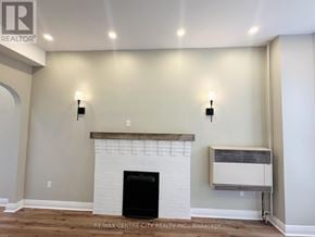 St. Thomas fourplex for rent - A living room with a fireplace and a wall-mounted air conditioning unit.