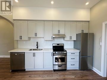 St. Thomas fourplex for rent - A kitchen with white cabinets and stainless steel appliances.