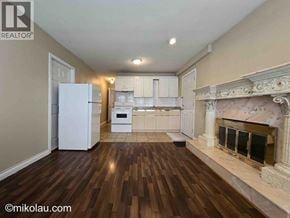 Burnaby apartment for rent - A well-lit kitchen with a fireplace and wooden floors.