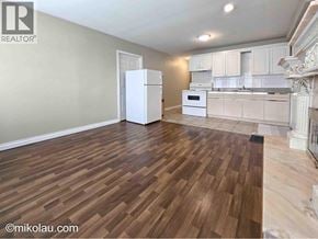 Burnaby apartment for rent - A kitchen with white appliances and wooden floors.