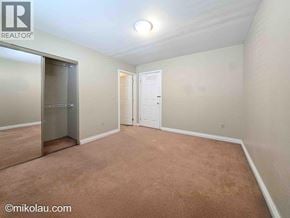 Burnaby apartment for rent - A room with a brown carpet and white walls.