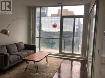 Toronto (Bay Street Corridor) condo for rent - A living room with a grey couch and a wooden coffee table.