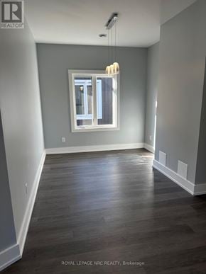 Welland (Welland Downtown) duplex for rent - A room with a window and wooden flooring.
