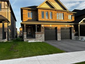 Barrie (Painswick South) apartment for rent - A modern house with a garage is shown in the image.