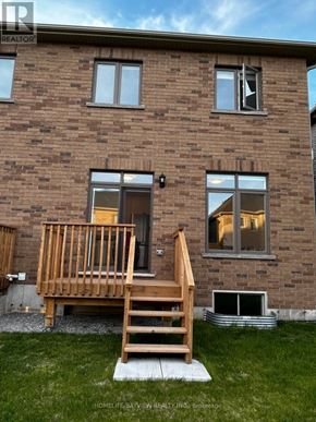Barrie (Painswick South) apartment for rent - A brown brick house with a wooden deck in front.