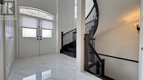 Markham (Berczy) apartment for rent - A spacious foyer with a staircase and a white marble floor.