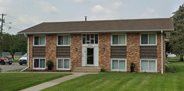 North Saint Paul apartment for rent - A two-story brick house with a white door and windows.