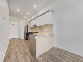 Surrey apartment for rent - A kitchen with a refrigerator, sink, and cabinets.