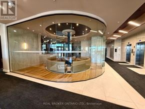 Ottawa condo for rent - A modern office lobby with a circular glass wall and a wooden floor.