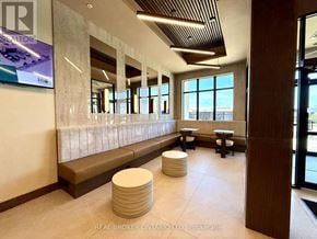 Ottawa condo for rent - A lobby with a bench and a large window.