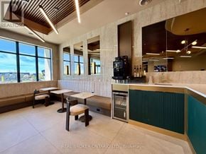 Ottawa condo for rent - A modern kitchen with a bar area and a view of the outdoors.