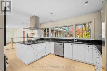 Toronto (Bridle Path-Sunnybrook-York Mills) apartment for rent - A modern kitchen with white cabinets and a black countertop.