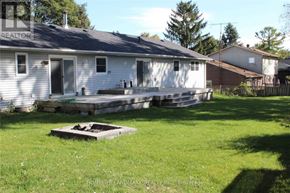 Whitchurch-Stouffville apartment for rent - A white house with a grey roof and a wooden deck in front.